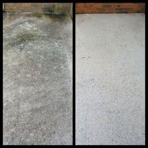 Side-by-side comparison of a concrete floor. The left side shows a dirty, mossy surface, while the right side displays a clean, freshly power-washed concrete area. Both sections are adjacent to a brick wall.