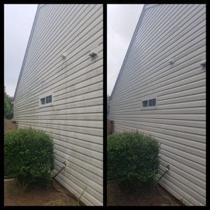 A split image showing the side of a house before and after power washing. On the left, the siding appears dirty with streaks and discoloration. On the right, the siding is clean and white. A green bush sits beside the house in both images.