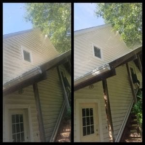 Side-by-side comparison of a house exterior before and after power washing. The left side shows the wall covered in dirt and grime, while the right side displays the same wall cleaned, revealing bright, clean siding and a clearer window. Trees and a door are visible.